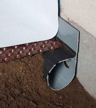 Closeup of a crawl space drainage system installed in Decatur