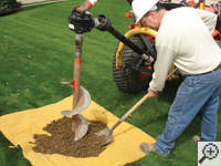 Auguring a hole in the earth for a foundation repair in Tucker