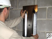 Mounting a foundation wall plate for an earth anchor installation in Newnan.