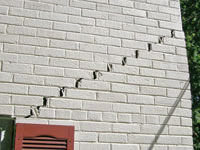 Stair-step cracks showing in a home foundation in Suwanee
