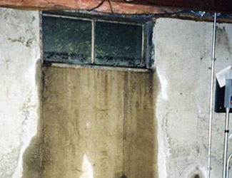 Water pouring out from a basement window in Marietta
